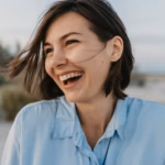 smiling-portrait-candid-laughing-woman-beach_285396-6719